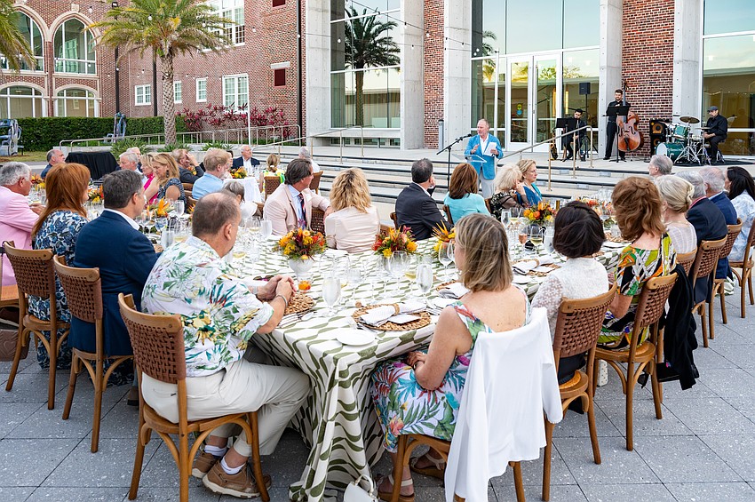 Michael Klauber explains his wine selections to dinner guests.