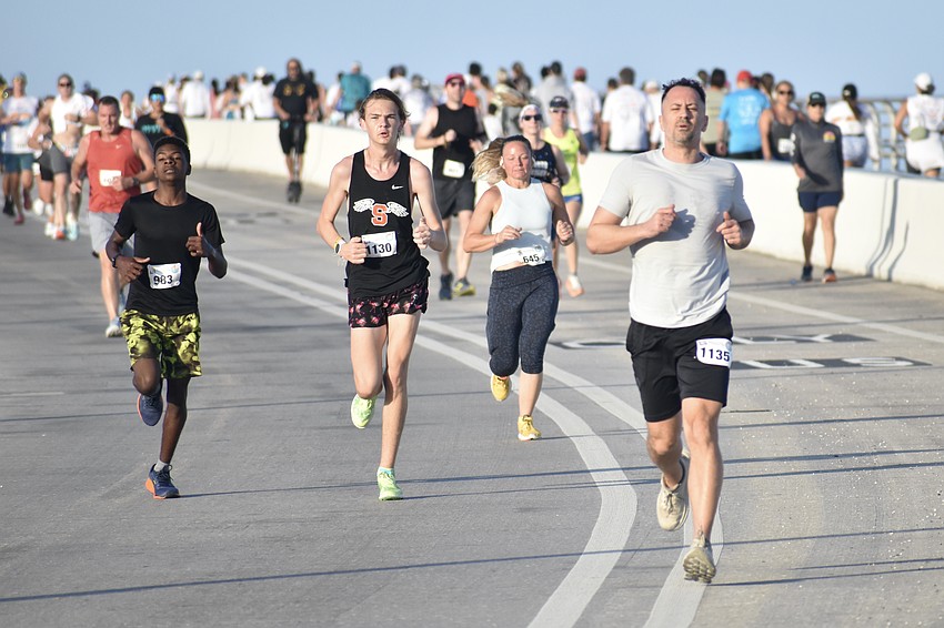 Davontay Richey, Andrew Light, Erin Skaggs and Cory Gallagher reach the end of the bridge as they make their way back across.