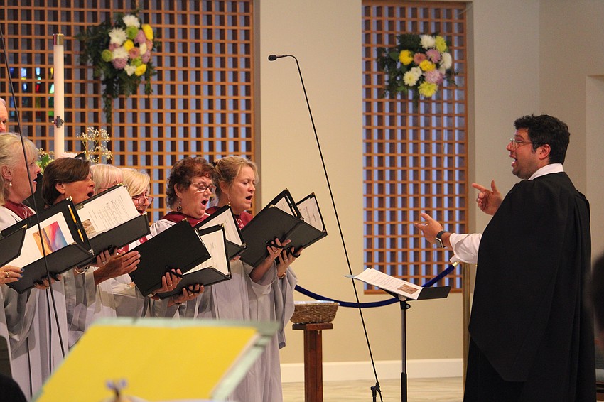 Michael Bodnyk, minister of music and director of operations at St. Armands Key Lutheran Church, leads the choir on Sunday.