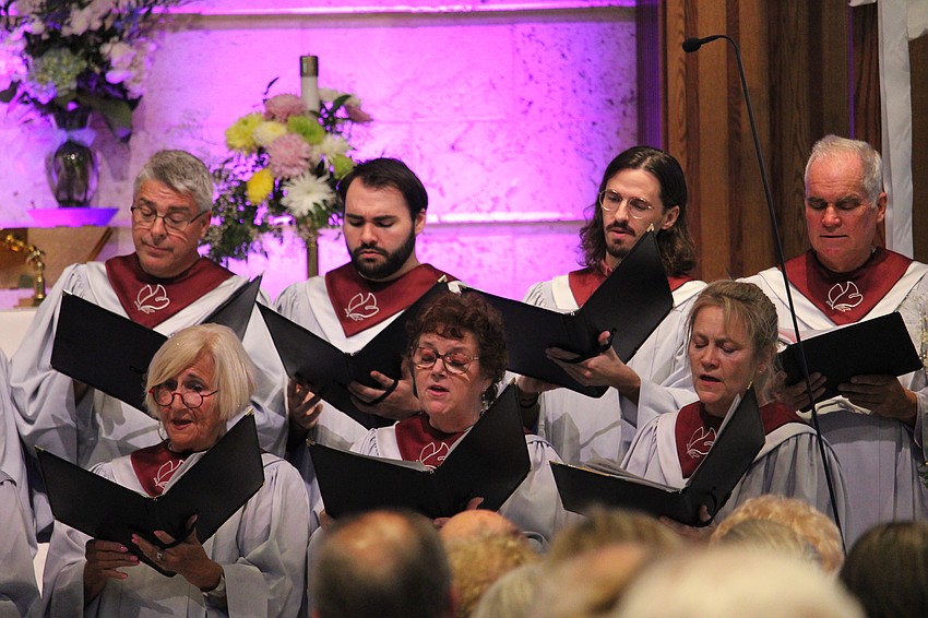 Choir members compliment John Behnke as he plays the new pipe organ at St. Armands Key Lutheran Church for the first musical event since its installation.