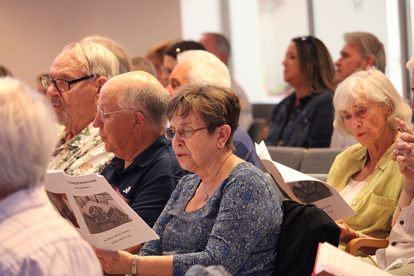 Congregation members sing along with the hymns at a special Easter-themed celebration at St. Armands Key Lutheran Church.