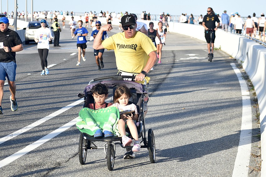 Erik Wydner pushes his kids Noah Wydner, 7, and Ellie Wydner, 5. 