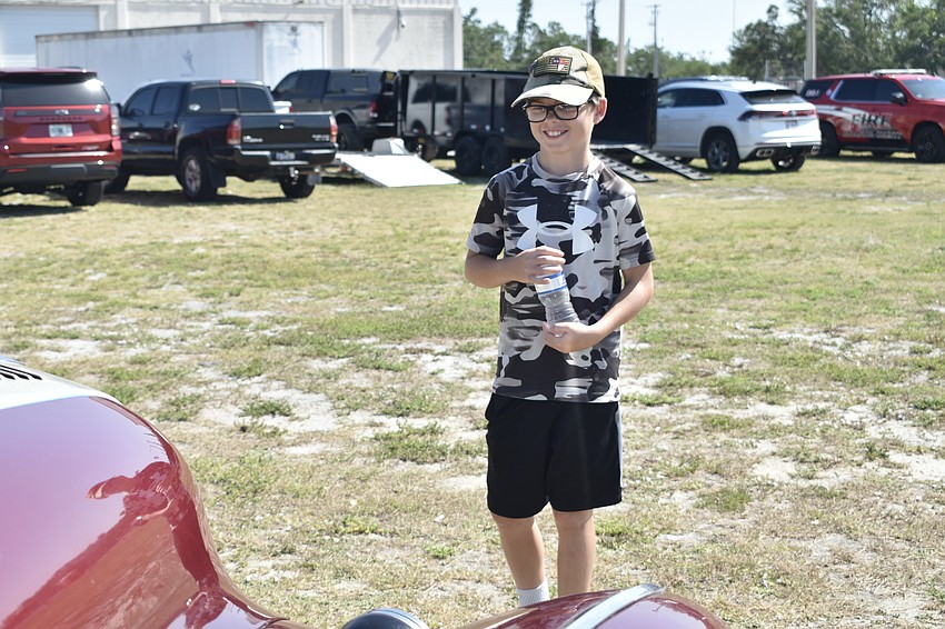 Noah Cochran, 11, looks at the 1947 Buick Super Sedanette owned by Wayne Stephens.