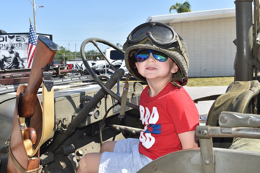 Sarasota's Kian Ayers, 5, sits in a 1945 Willys MB Jeep from World War II, owned by Dale Aylward of Parrish. His mother Marcy Ayers said he has a fascination with military history, which began after he saw the purple heart of her grandfather Edwin Payne, who was wounded in Vietnam.