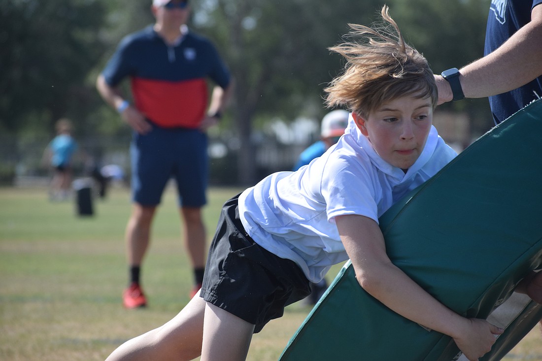 Camden Tippett, 12, lays out to tackle a tackling wheel during a drill at a Nextlevelz clinic in Lakewood Ranch on April 26.