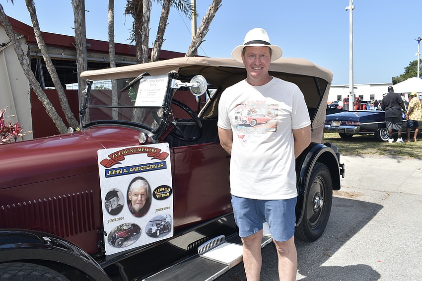 Captain Dana Anderson, vice president of the Sarasota Firefighters Benevolent Fund, poses next to the 1925 Dodge Brothers Touring car owned by his father John Anderson, who died in June and had been coming to the show since the 1970s.