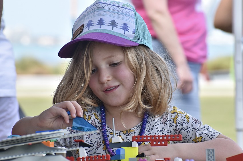 June Bernstein, 3, works on a brick project.
