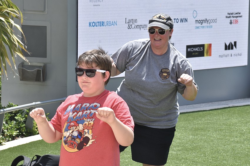Luke Doyle, 9, and his mom Emily Hanson, participate in the tai chi activity, which is led by Hanson's mother Gail Pettit.