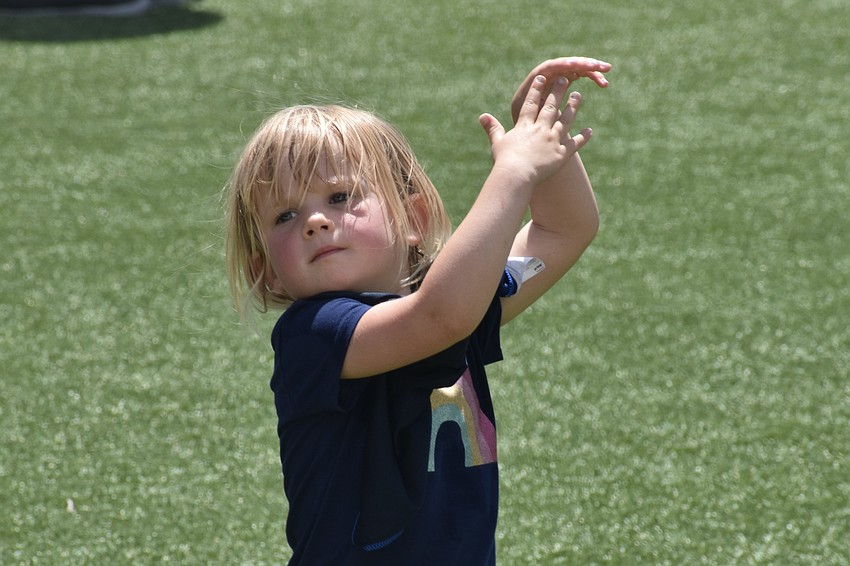 Maeve McLean, 3, participates in the the tai chi activity.