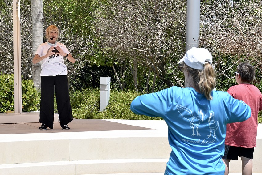 Gail Pettit leads Frances Bermudez of The Bay, and Pettit's grandson Luke Doyle, 9, in tai chi.