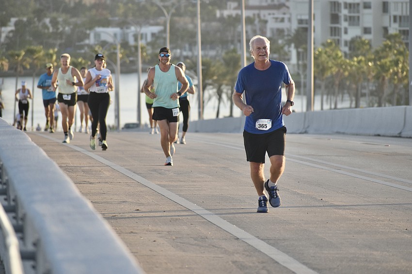 Participants, including Scott Parrish (front) make their way over the bridge.