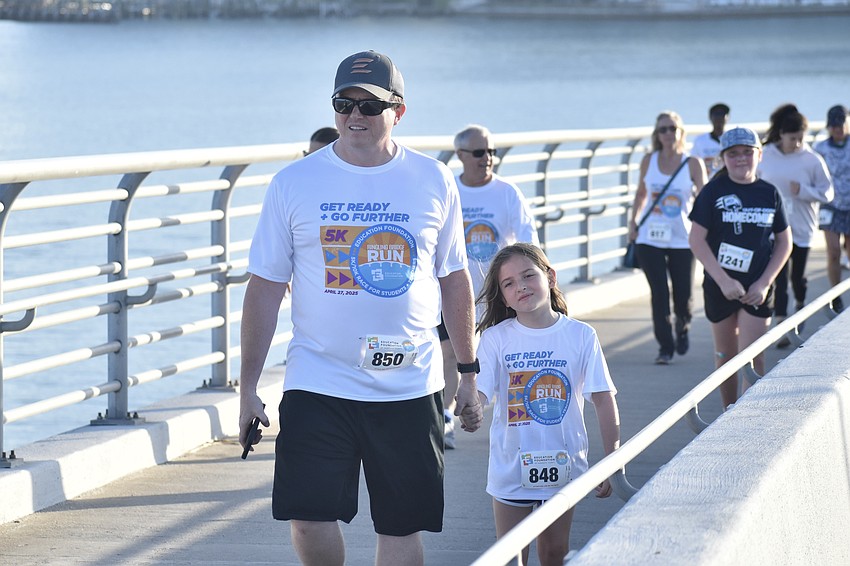 Evan Randall and T. Randall, 7, head along the walkway.