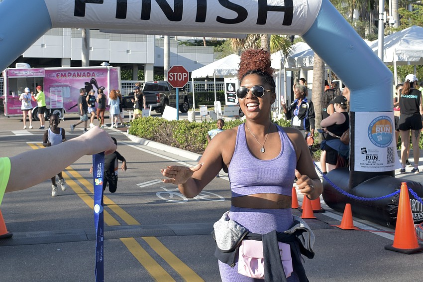 Jazmine Davis claims a medal at the finish line.