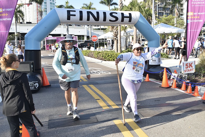 James Hawkins and Mayra Hernandez arrive at the finish line.