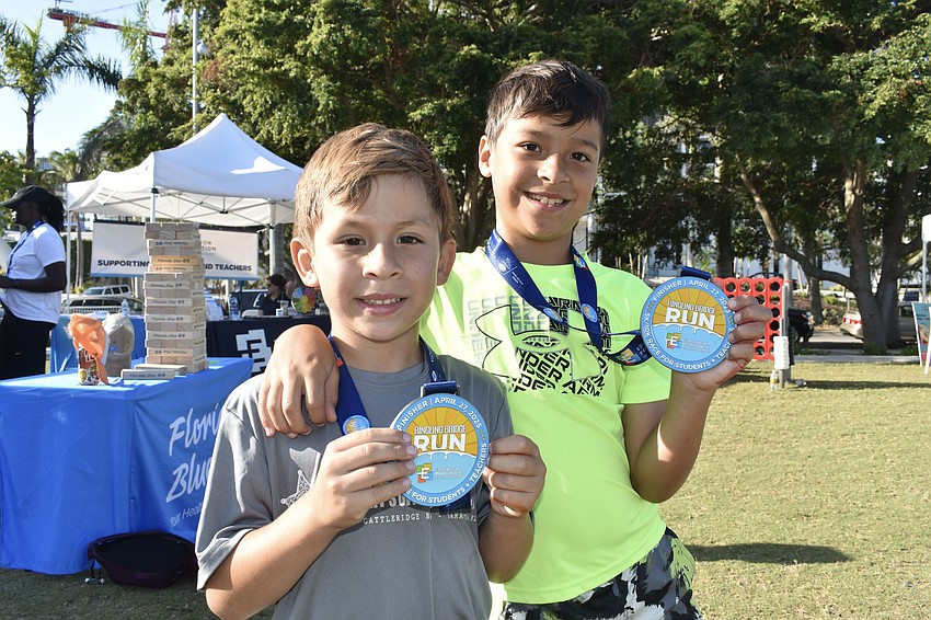 Diego Chappa, 6, and his brother Tadeo Chappa, 8, showcase their medals.