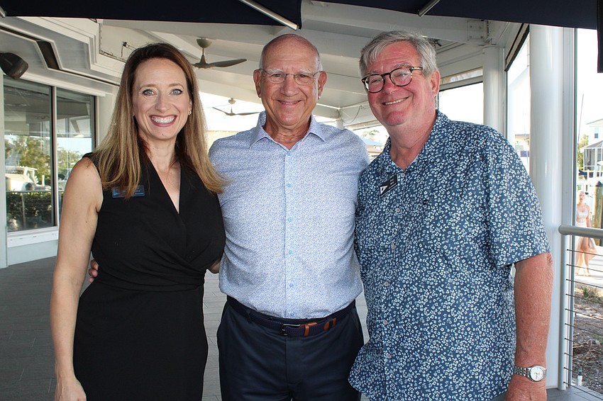 Bird Key Yacht Club General Manager Tammy Hackney, Commodore Michael Landis and Vice Commodore Tony Britt prepare to open the time capsule.