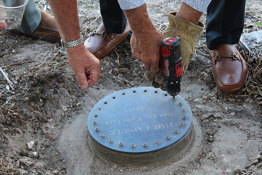 The concrete-encased time capsule was securely fastened with screws and tightly suctioned closed, but Bird Key Yacht Club General Manager Tammy Hackney came to the rescue with tools to help.