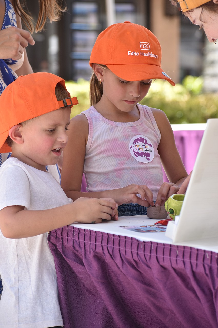 Pierro Konkel, 4, and Fabiana Konkel, 6, work on a pottery project.