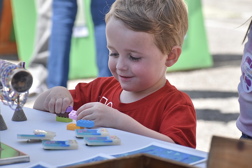 Spencer Brown, 4, assembles some colorful bricks.