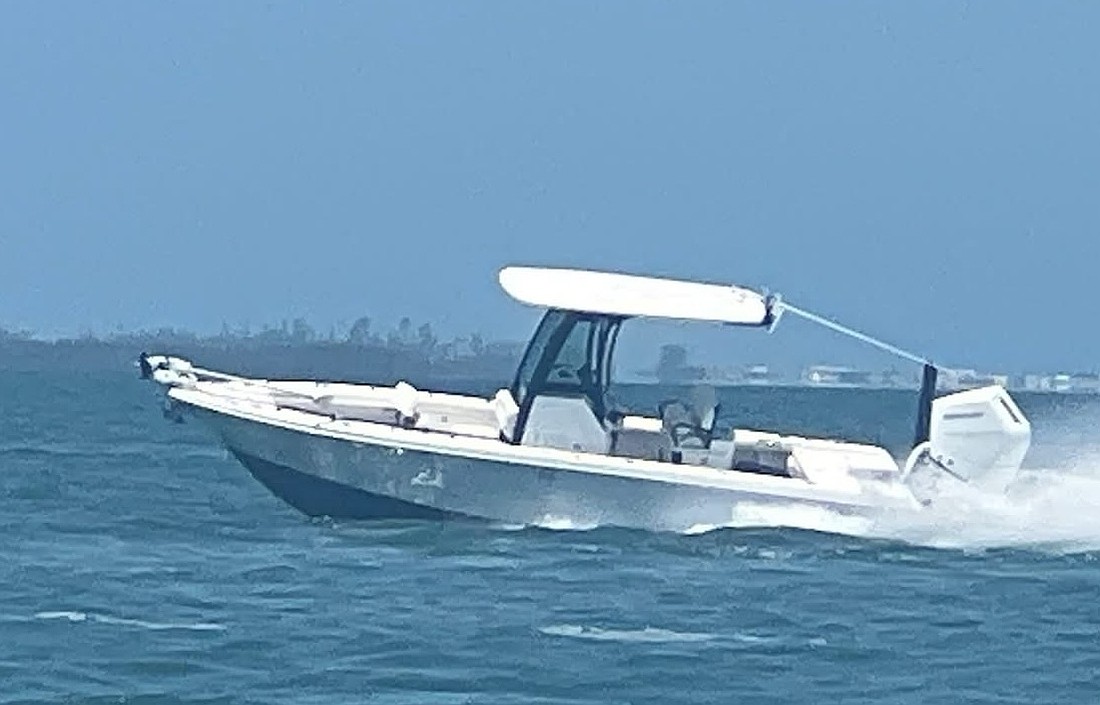 The operator of this 26-foot boat fell overboard, prompting police to chase and eventually leap aboard the moving craft.