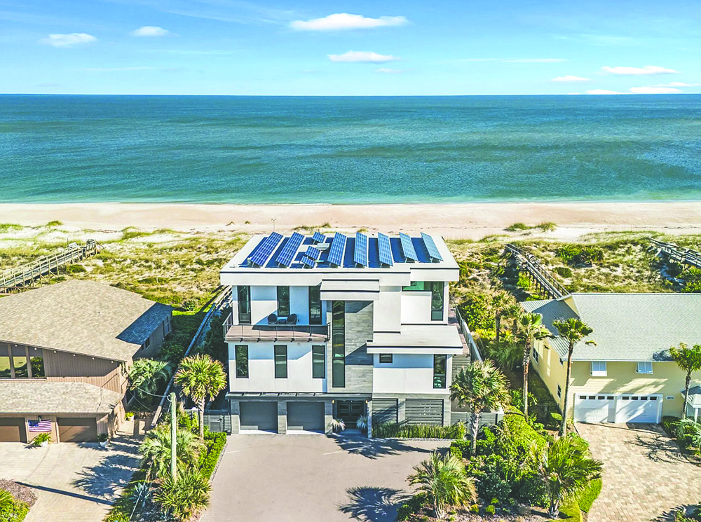 Oceanfront three-story contemporary home features five bedrooms, three full and two half-bathrooms, office, media room, porches, deck, balcony, pool and rooftop solar system.