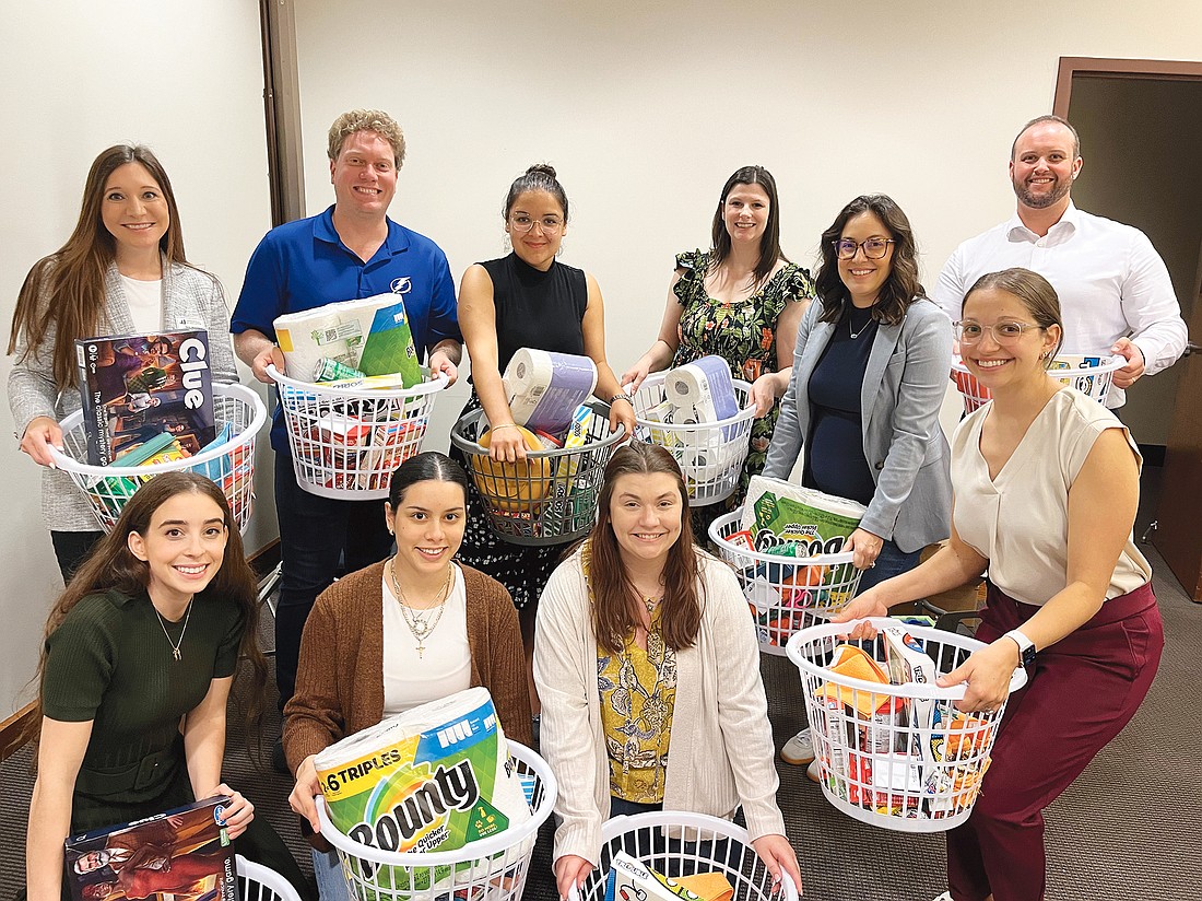 Front row, from left: Julianna Favale, Susan Cavailhon, Sydney Schmidt and Alina Fernandez. Back row, from left: Sarah Morris, Daniel O’Byrne, Paige Cham, Alexandra Underkofler, Kayla Haines Herrin and Austin Sherman. The group filled baskets to help Family Support Services of North Florida.