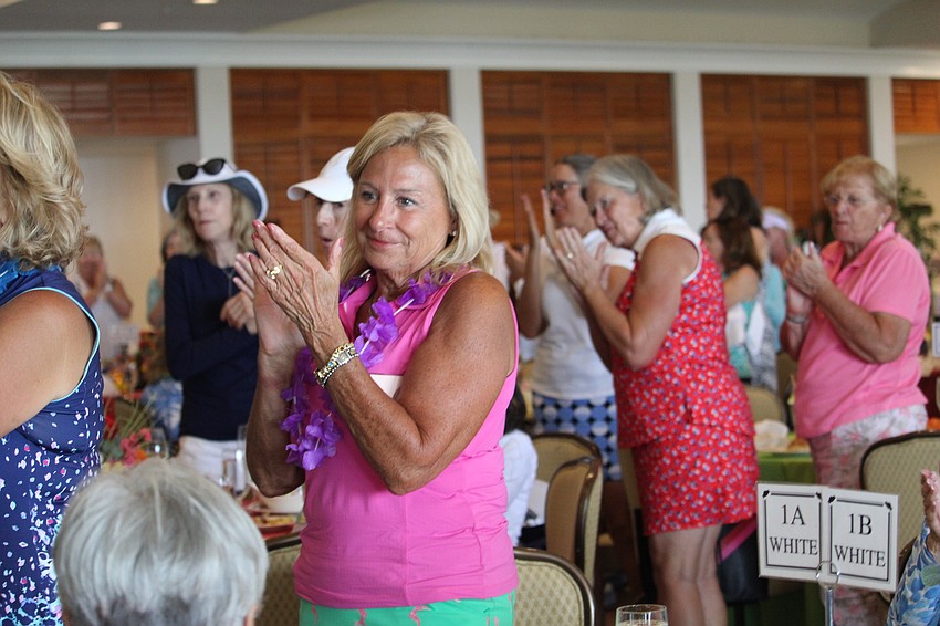 Members of the Women's Golf Association applaud outgoing president Lyn Haycock.