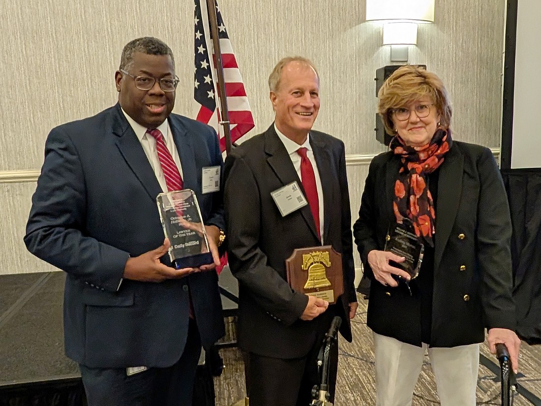 Jacksonville Daily Record 2025 Lawyer of the Year Octavius Holliday, Liberty Bell Award winner Dennis Harrison and William J. Sheppard Lifetime Achievement Award winner Audrey Moran at the Jacksonville Bar Association Law Day luncheon on May 1.