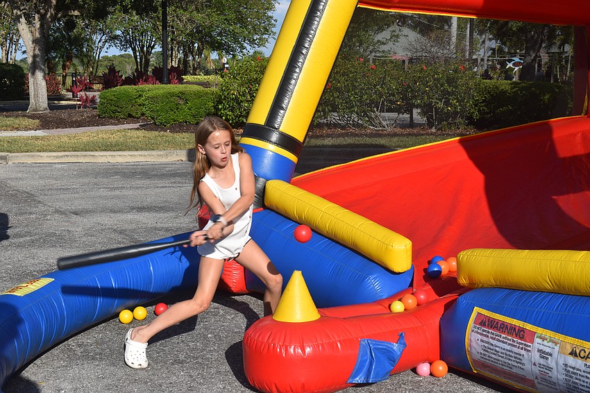 Parrish resident Ayden Misiak, 8, came to Lakewood Ranch to meet friends for dinner, but ended up having lots of fun swinging the bat at the Batter Up inflatable.