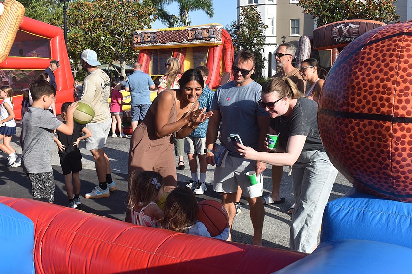 Sarasota residents Kavita Tisdale and her husband Brice Tisdale attempt to get their daughter Alia Tisdale and her friend Cecilia Pais to smile while Trish Slevin, Cecilia's mom, takes their photo.