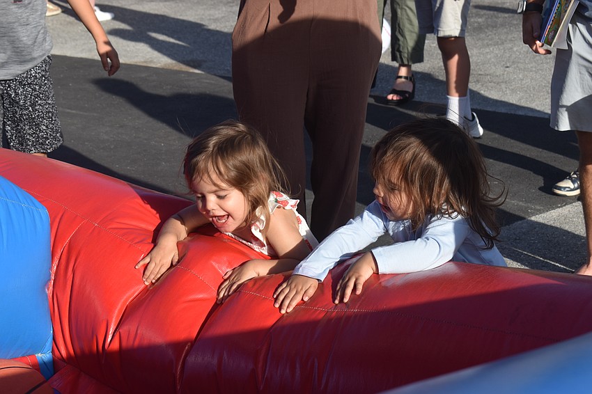 Sarasota resident Alia Tisdale, 2, and Denver, Colorado resident Cecilia Pais, 2, reach for basketballs to continue playing their game. They met as babies and have reunited.