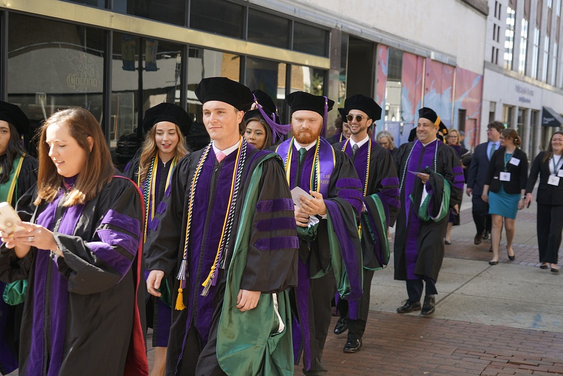 The first 13 graduates of the Jacksonville University College of Law walked from their urban campus at 121 W. Forsyth St. to the Duval County Courthouse for their commencement ceremony May 2.