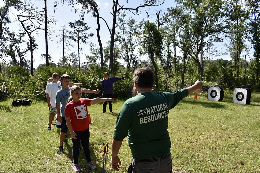 The archery class is first taught with pretend bows and arrows. Students are given equipment after they've run through all the steps.