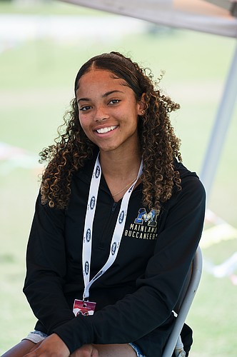 Mainland senior Kiera Williams supports her teammates at the Region 2-3A track and field meet on May 2 as she sits out due to a knee injury. Photo by Michele Meyers