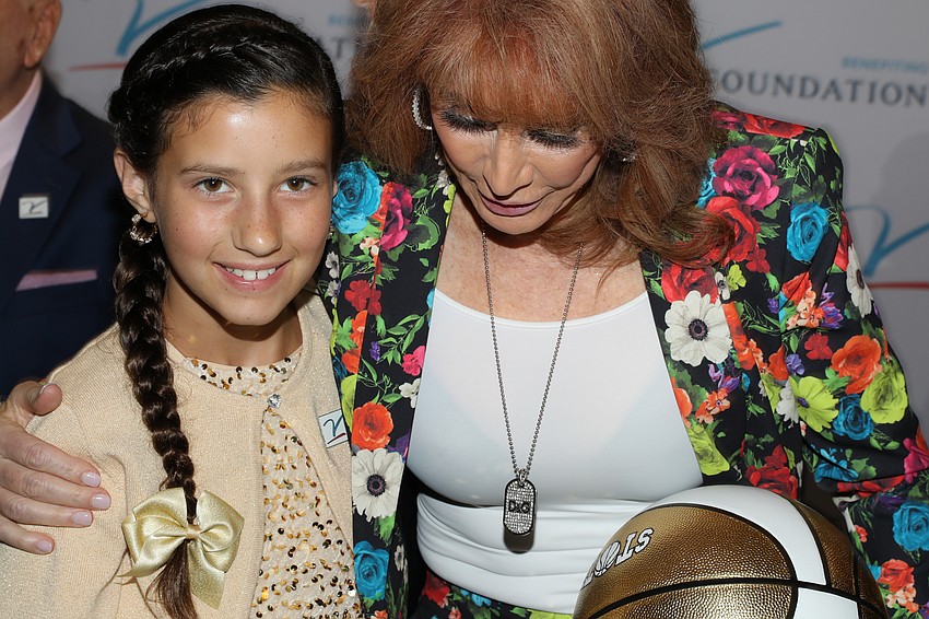 Chloe Grimes gets an encouraging hug from former WNBA player and coach and current Oklahoma City Thunder Broadcaster Nancy Lieberman. Lieberman also takes home the Dick Vitale Spirit Award.