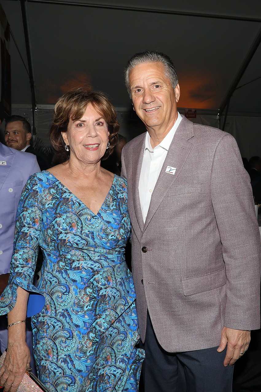 Lorraine Vitale is photographed with Arkansas head basketball coach John Calipari.