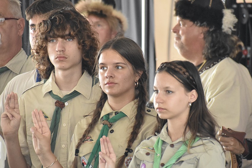 Siblings Otto Guraly, 14, Nikki Guraly, 16 and Angela Guraly, 14, stand as the Hungarian and American national anthems are performed.