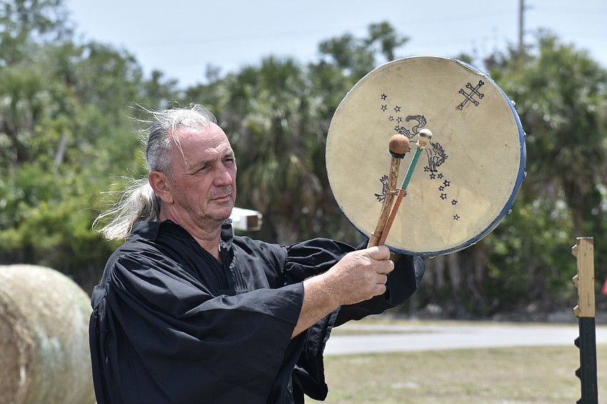 Attila Toth beckons attendees to the archery show.
