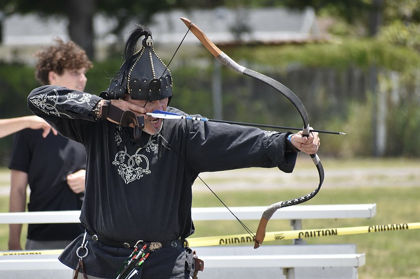 Robert Szalay shoots an arrow.