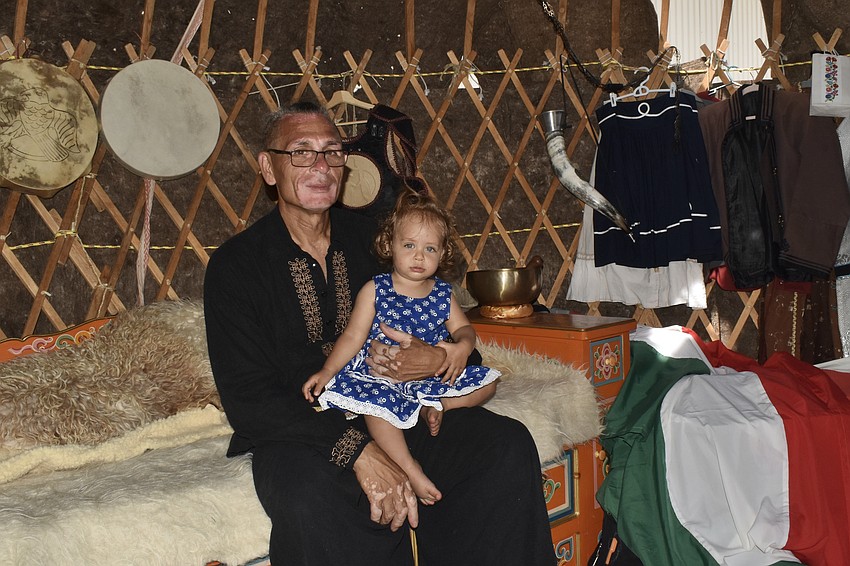 Istvan Lakatos and his daughter Reka Lakatos, 1, of Clearwater, sit inside the family's yurt, a type of portable tent home.