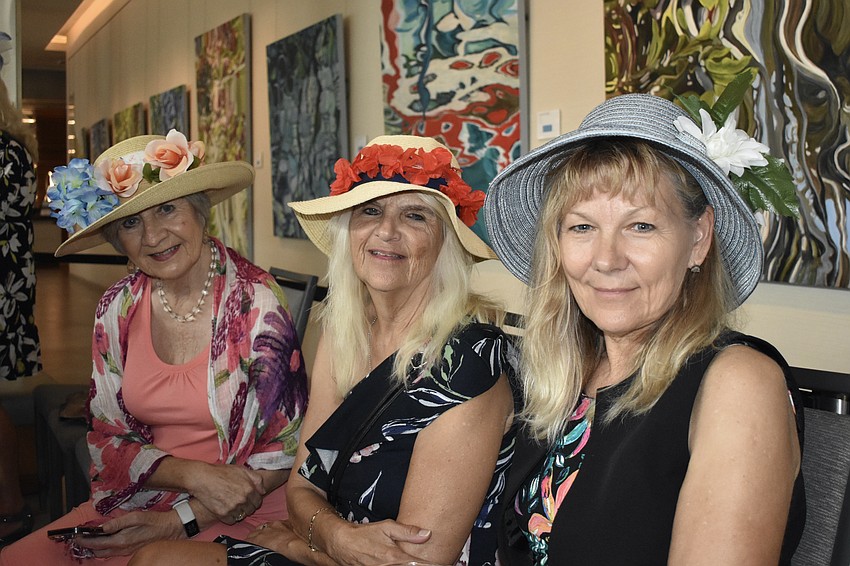 Lynne McLeod, Joanne Madeley and Liz Desrosiers watch the musical performance together.