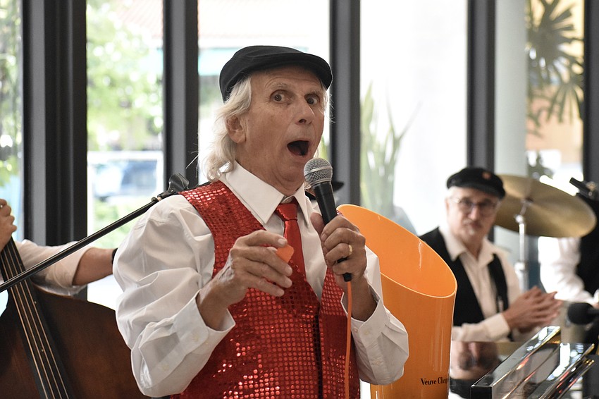 Musician Eddie Kinder makes a call for the raffle.