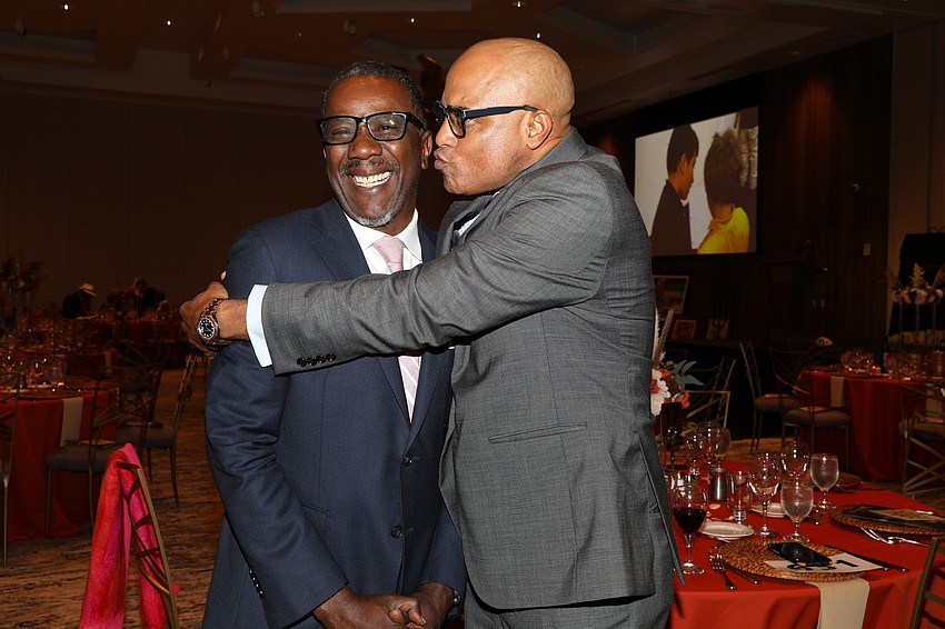 Co-Chair Jeff Gaines gets a kiss from co-Chair Edward Valdez.