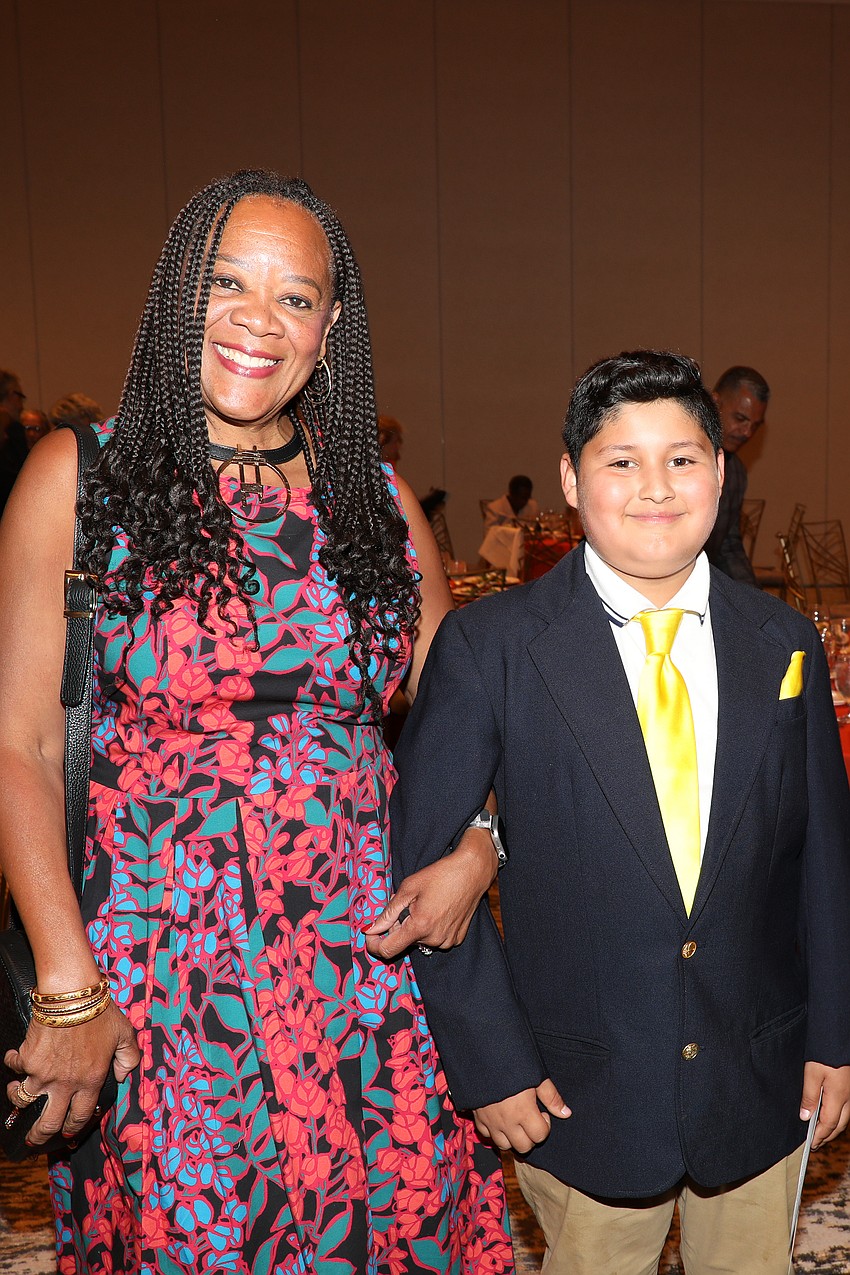Terry Wilkins is escorted into the VMA Shine On gala by Marvin Flores.