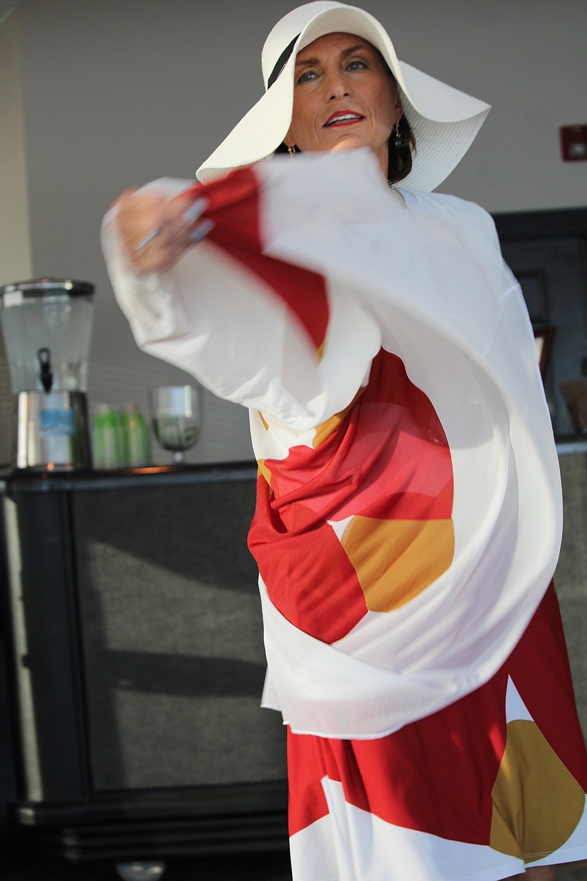 FemCity board member Michele D'Ambrosio gives her dress a swirl at the fashion show.