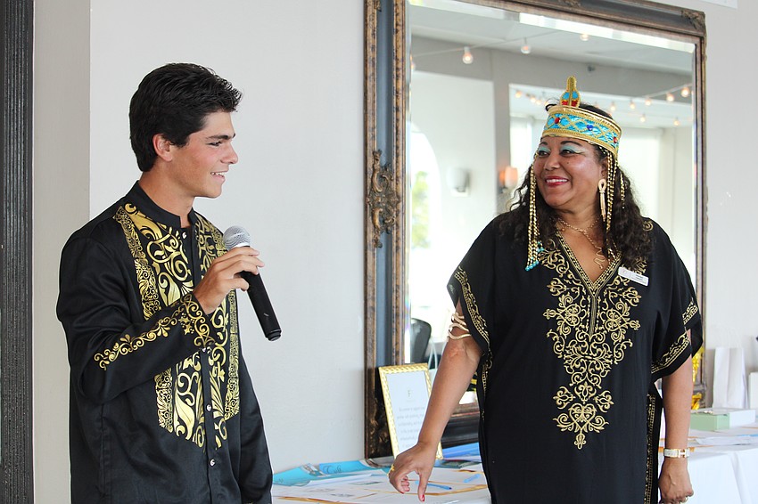 Volunteer Gavin Karlin helps run the Egyptian Night fundraiser with organizer Medge Jaspan on Friday at Marina Jack.