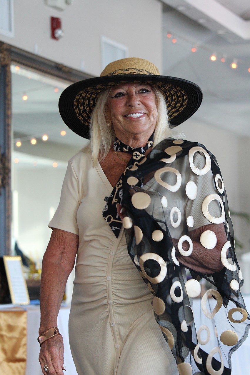 Gloria Pacheco stuns with her sheer shawl and smile on the FemCity runway.