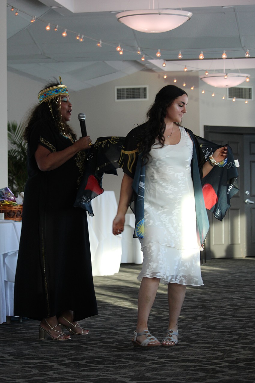 Medge Jaspan shows off some of the details in the design of the shawl Victoria Konsavage models.