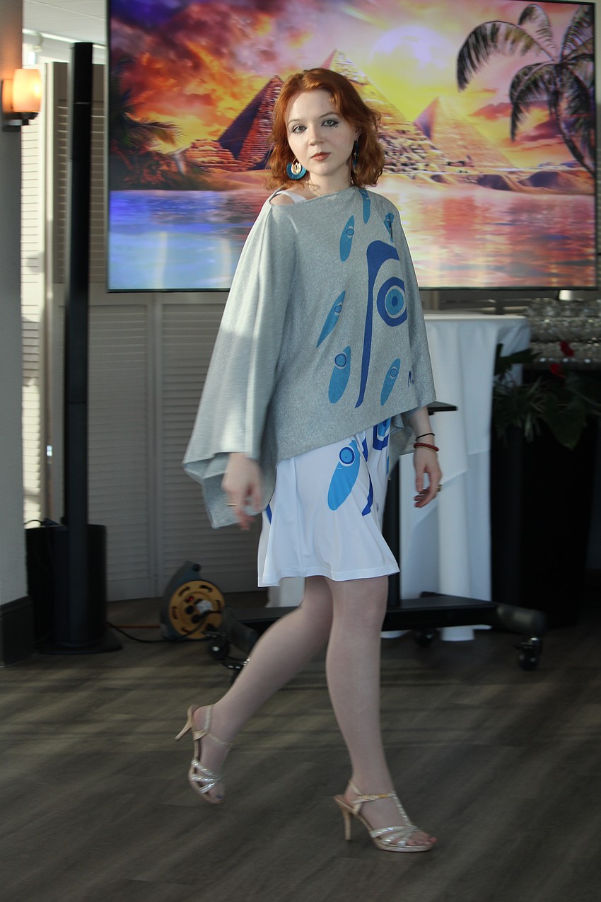 Jackie Williams walks in front of the Egyptian-themed background for this year's fashion show.