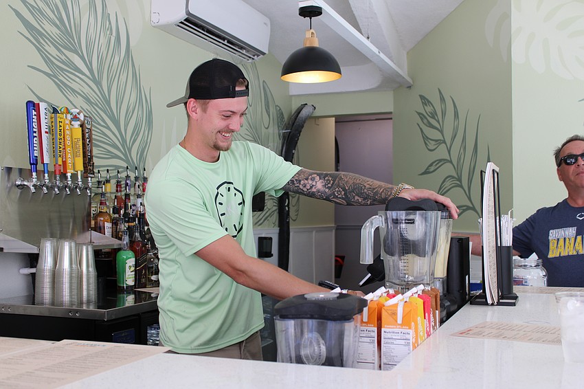 T.J. McKenna tends bar at the official reopening of O'Leary's Tiki Bar & Grill on Friday.
